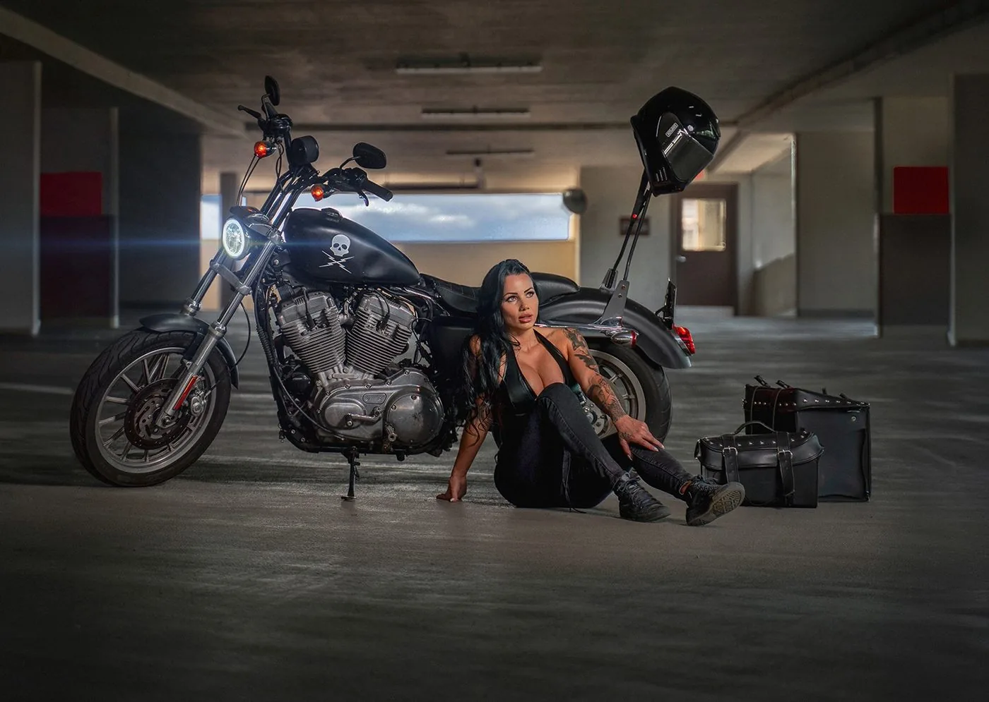 Woman with a motorcycle in a parking garage