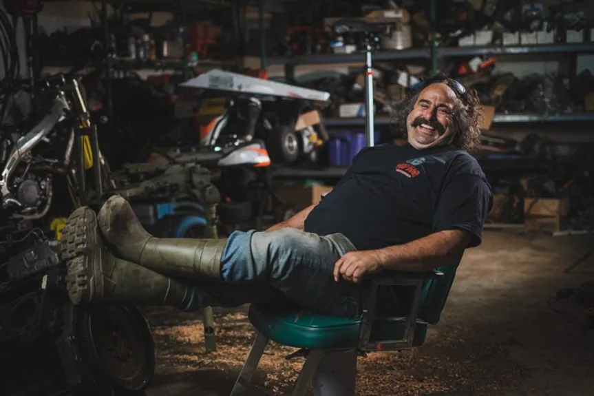 Mechanic relaxing in a car repair shop