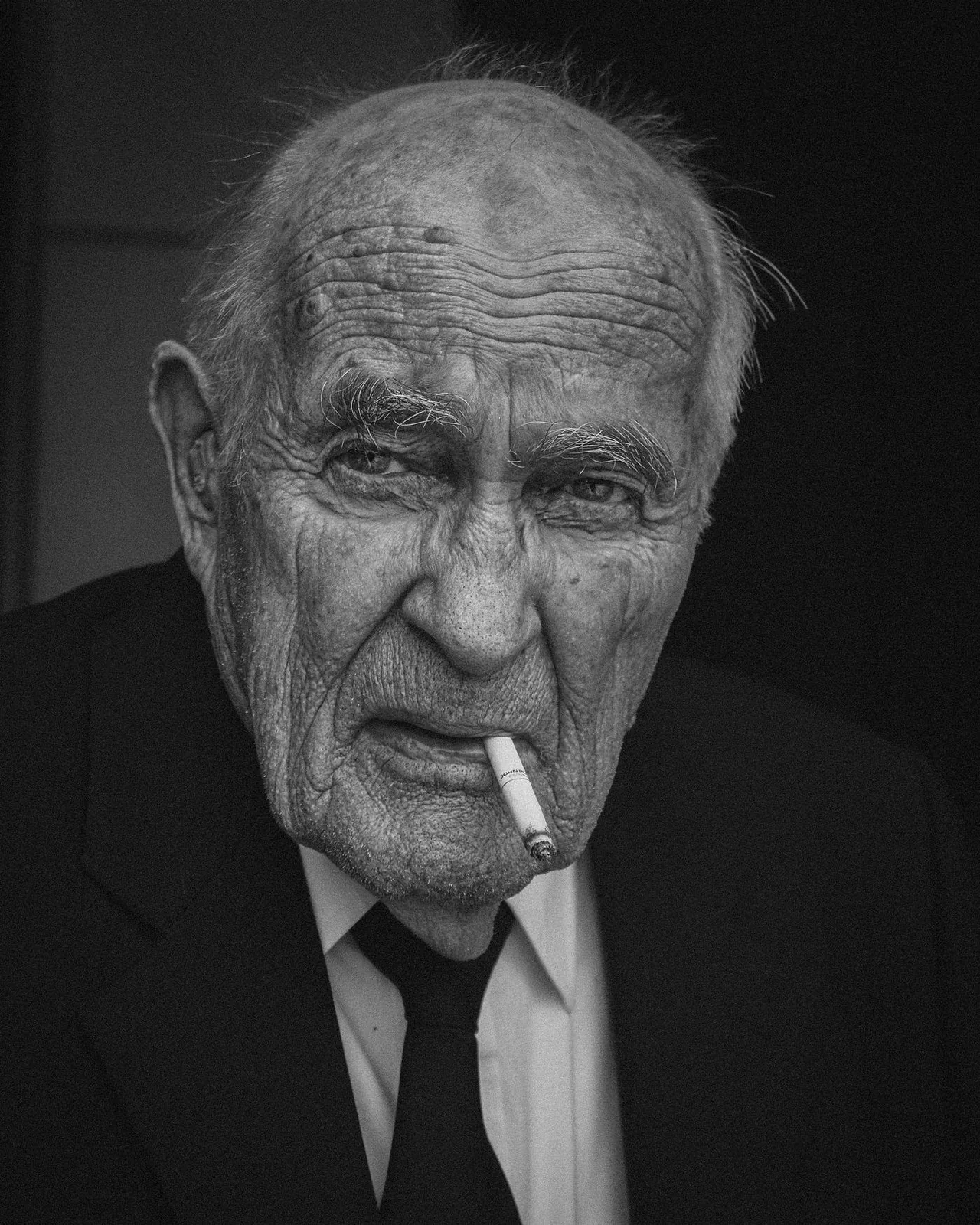 Black and white character portrait of an older man